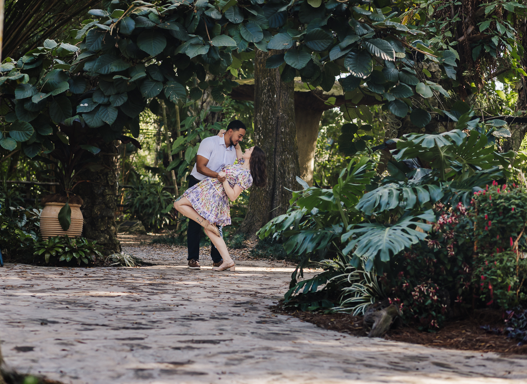Groom-to-be dips fiancée during romantic moment at McKee Botanical Garden on the Treasure Coast.